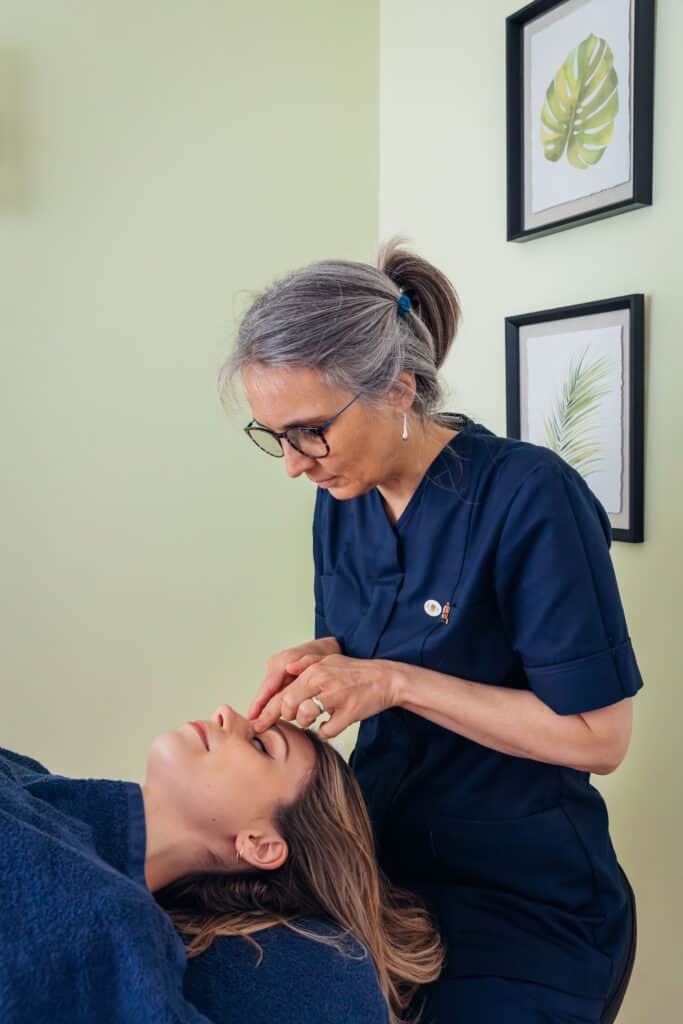 Juanita Duffin giving AromaTouch treatment in West Moors Healthful Mind Clinic